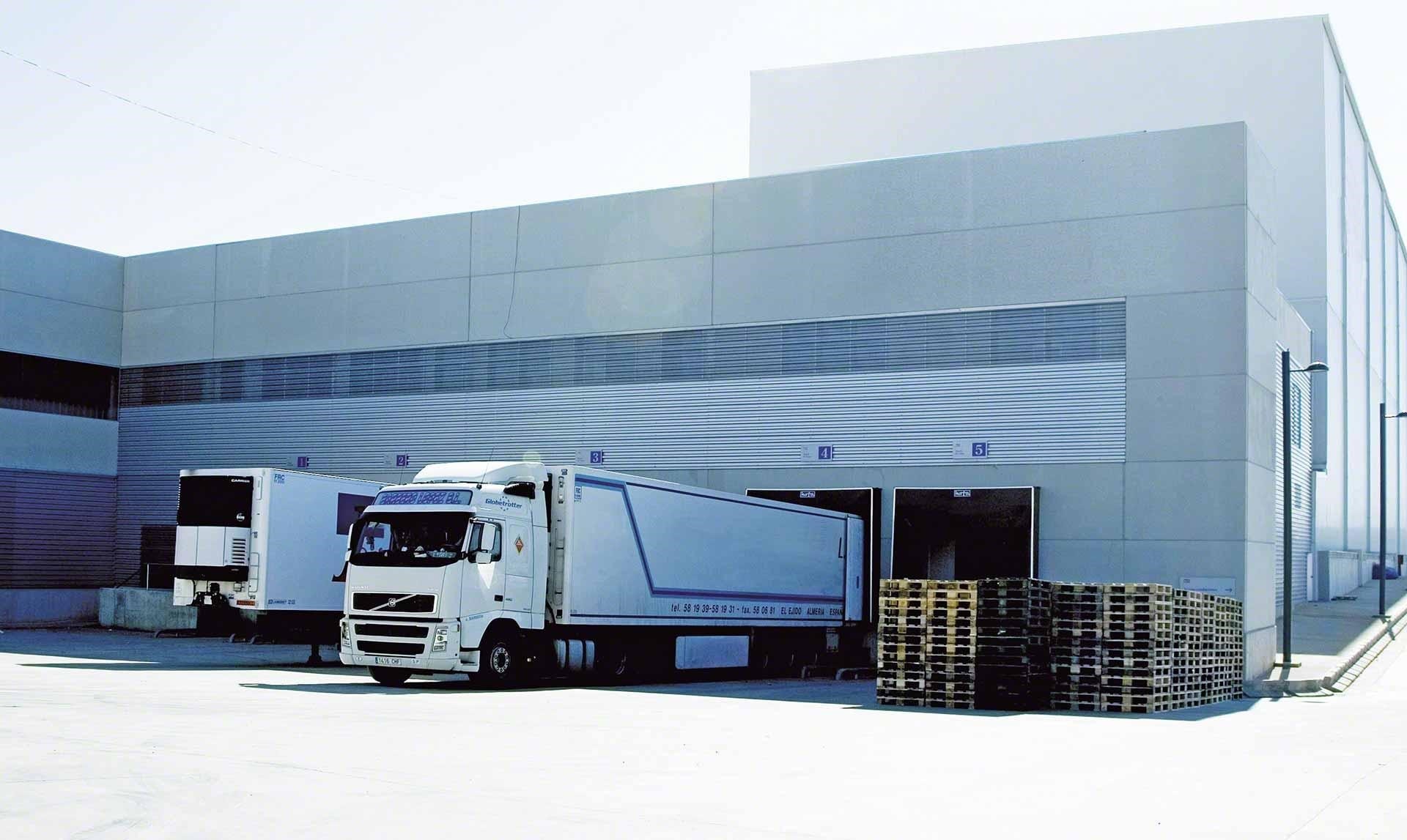Trucks unload goods in the warehouse as part of cross-docking operations